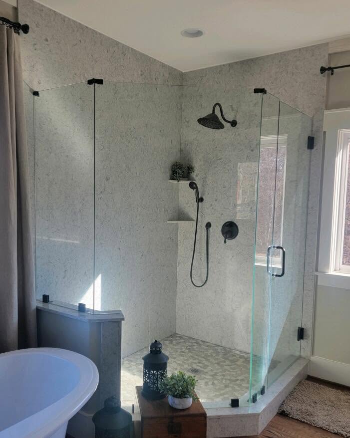 Bathroom shower enclosure with full-height stone walls and pebble floor